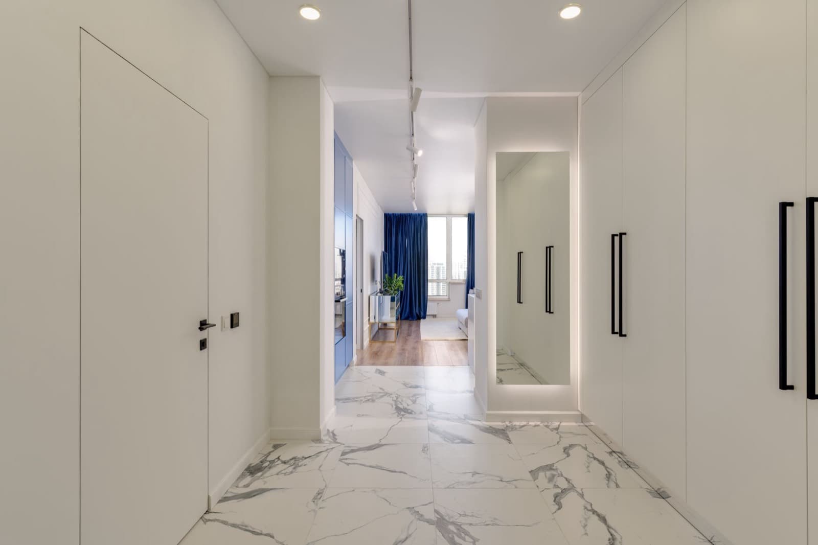 A bright corridor with a row of closed doors