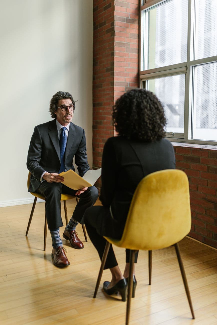 An interview underway between two people in a bright room