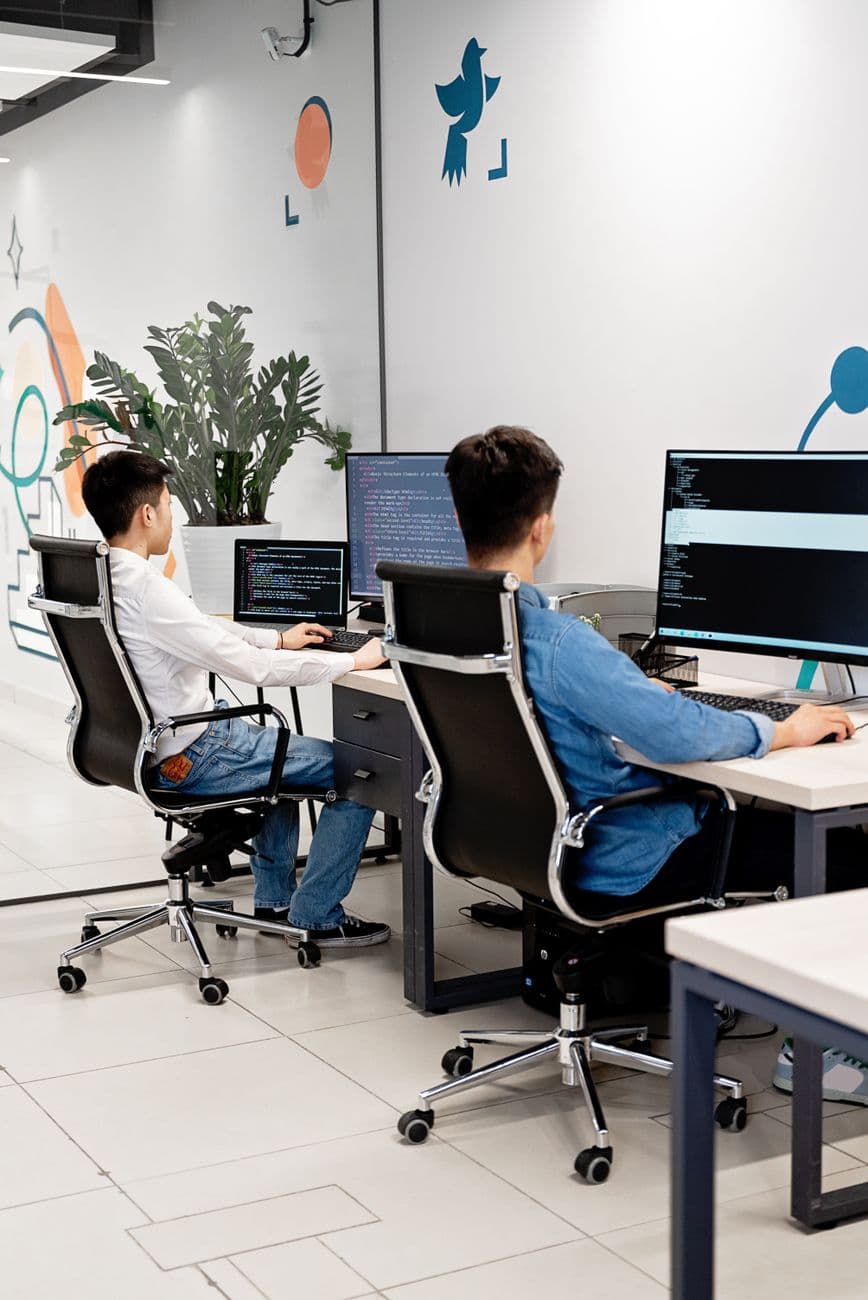 An engineer at a multi-screen workstation