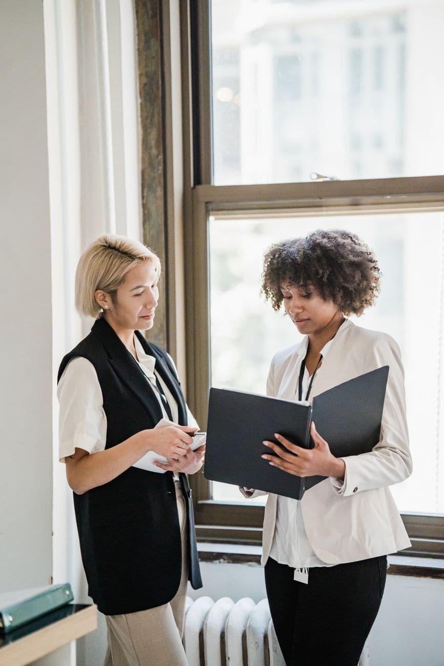 Two consultants reviewing a document together