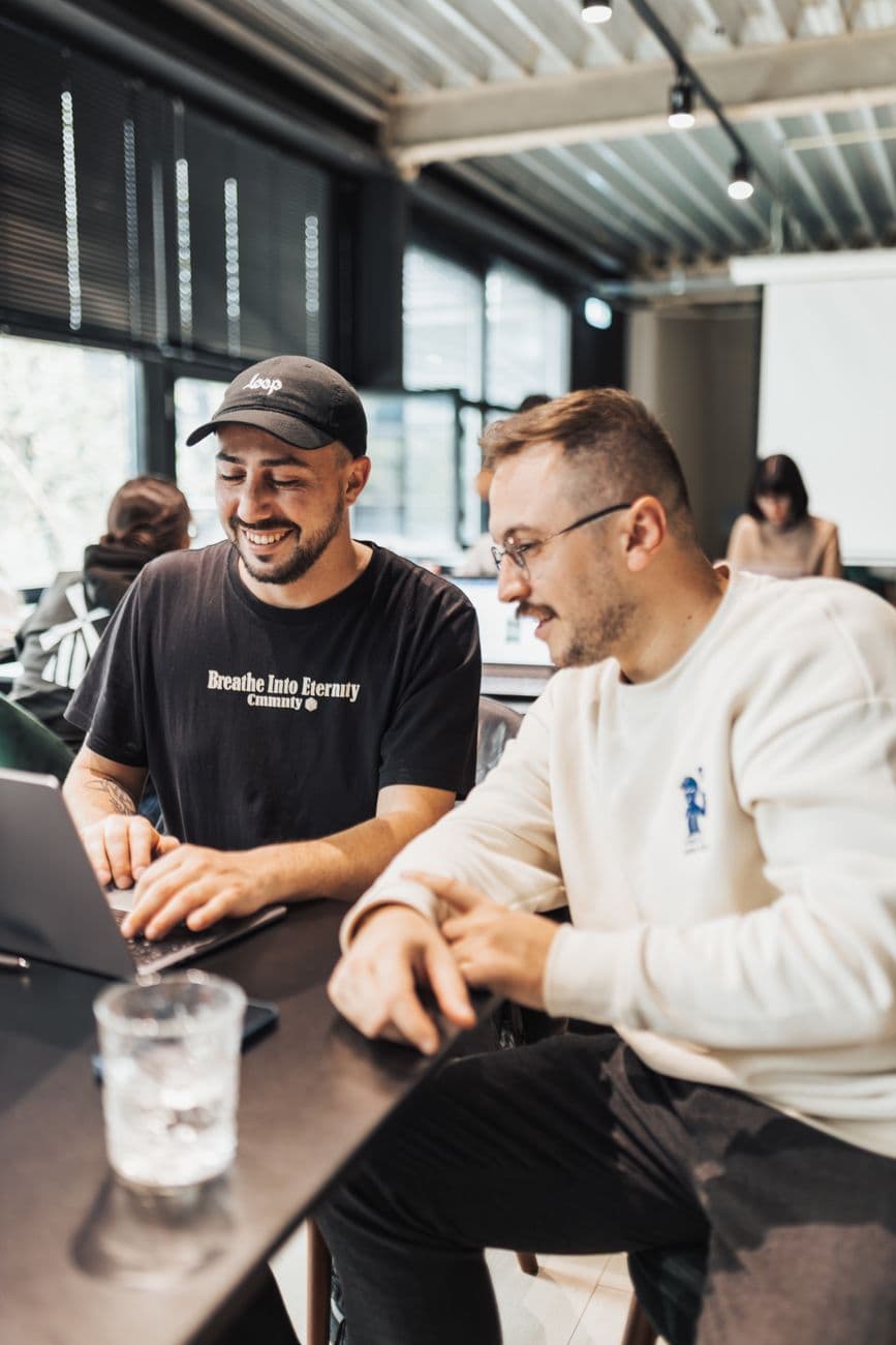Two founders working over a laptop
