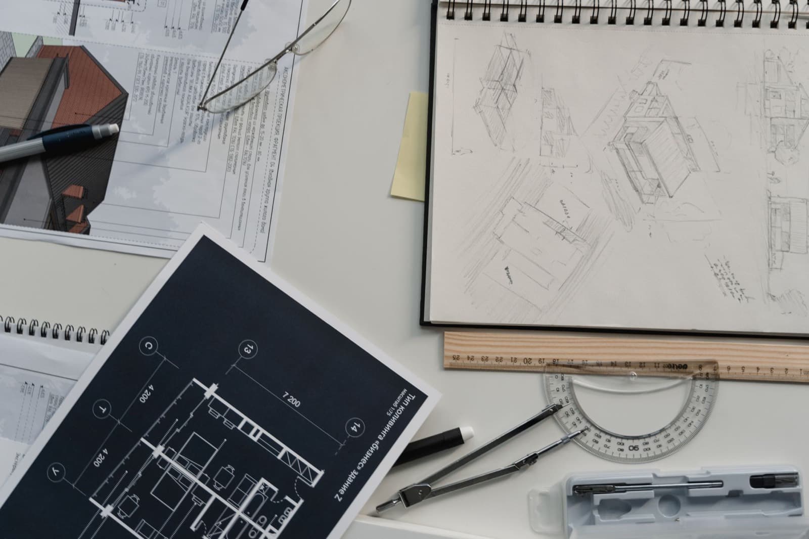Architectural drawings and a scale rule laid out on a desk
