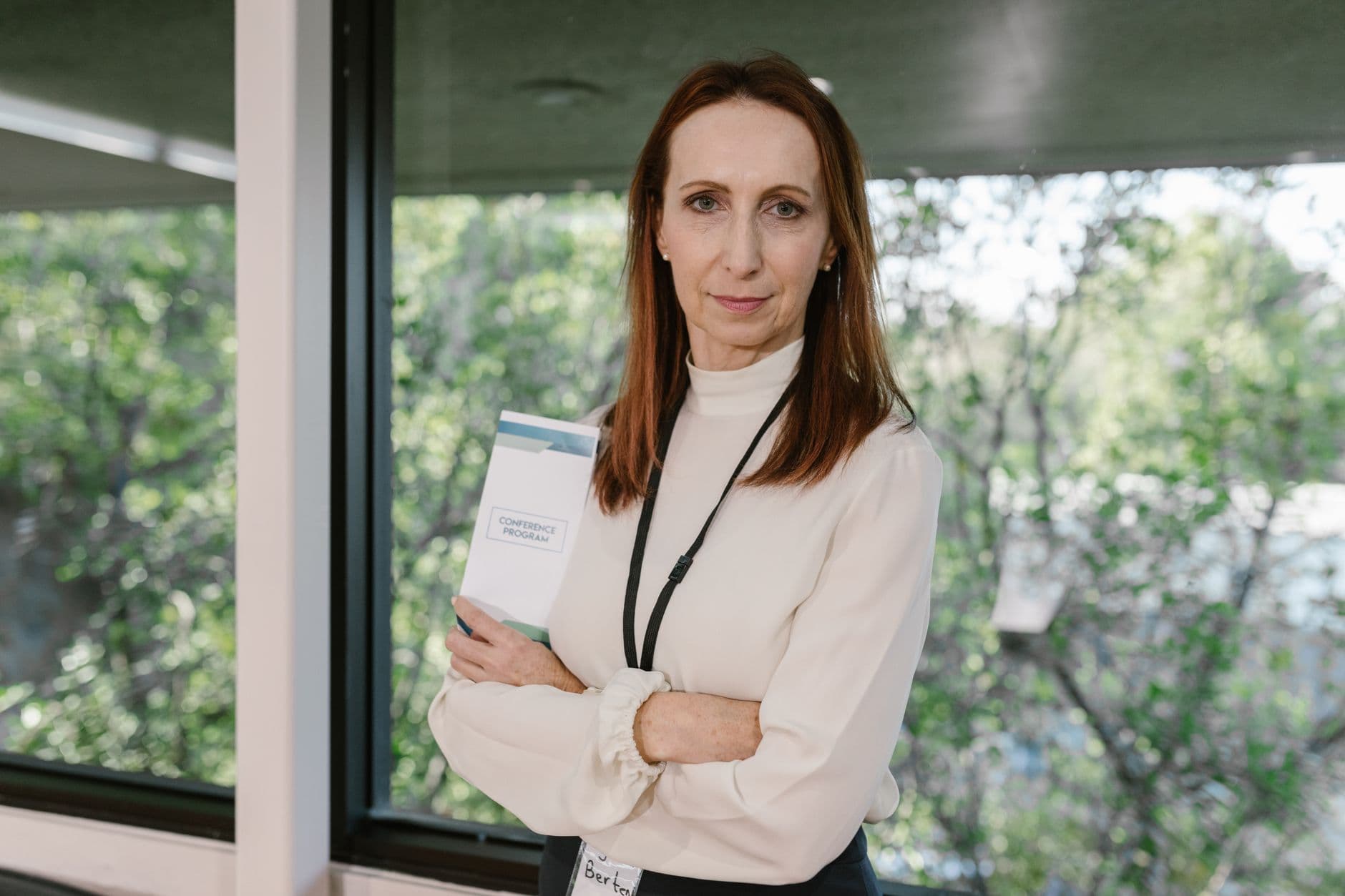 A senior executive standing with a document in an office