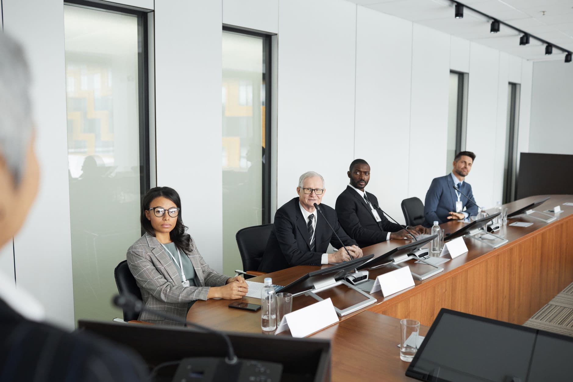 A board meeting in progress along a long table
