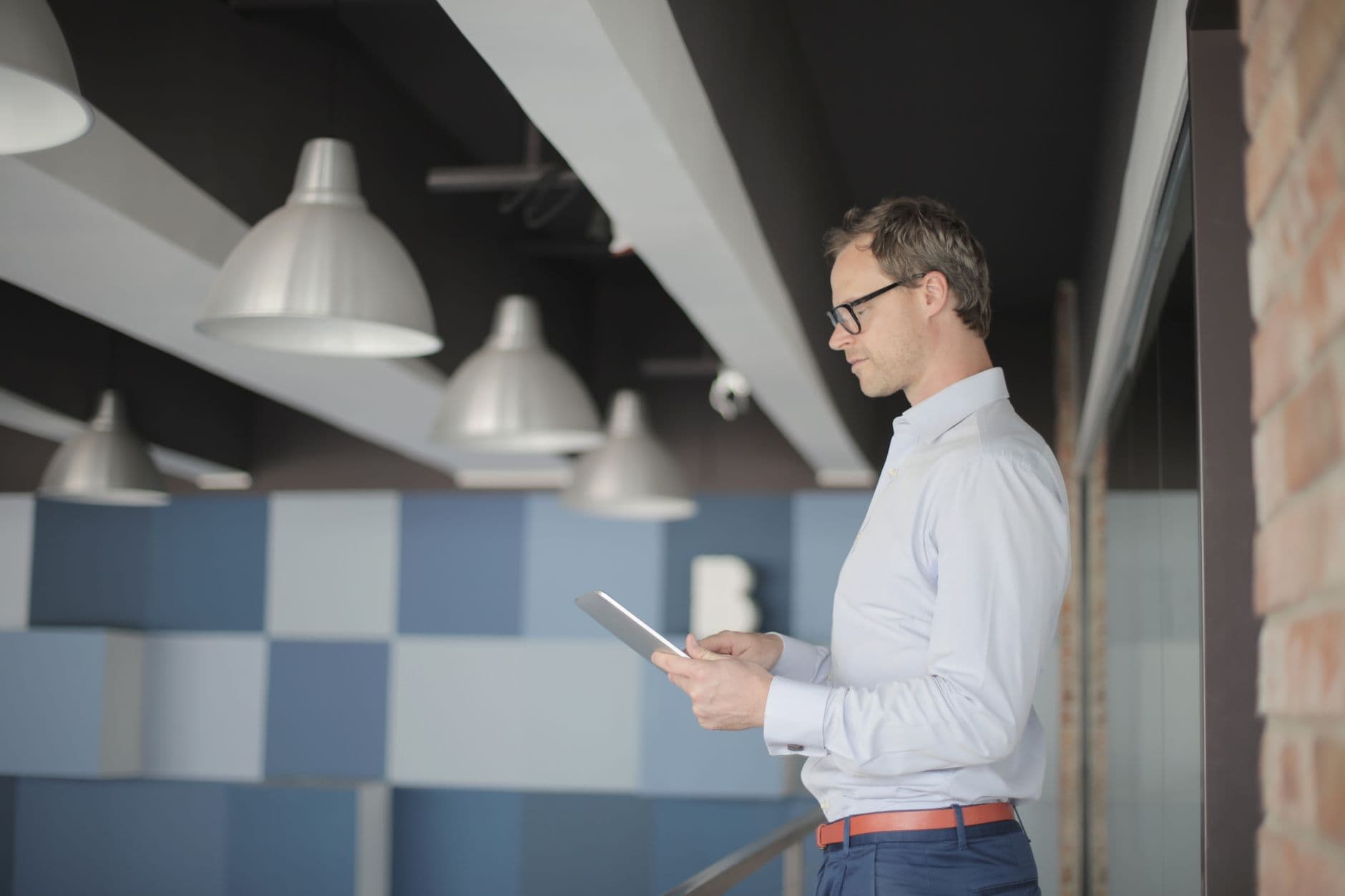 A manager reviewing papers on an office floor