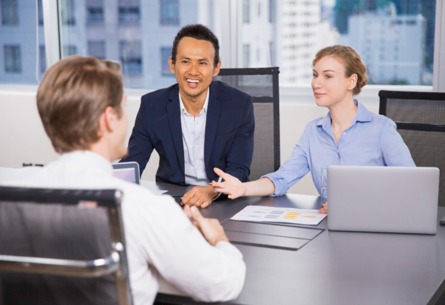 Group of happy business people discussing business ideas at meeting in office. Teamwork concept